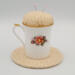 This is the back of the teacup showing different flowers and sitting on the trivet. This is the back of the teacup showing different flowers and sitting on the trivet.